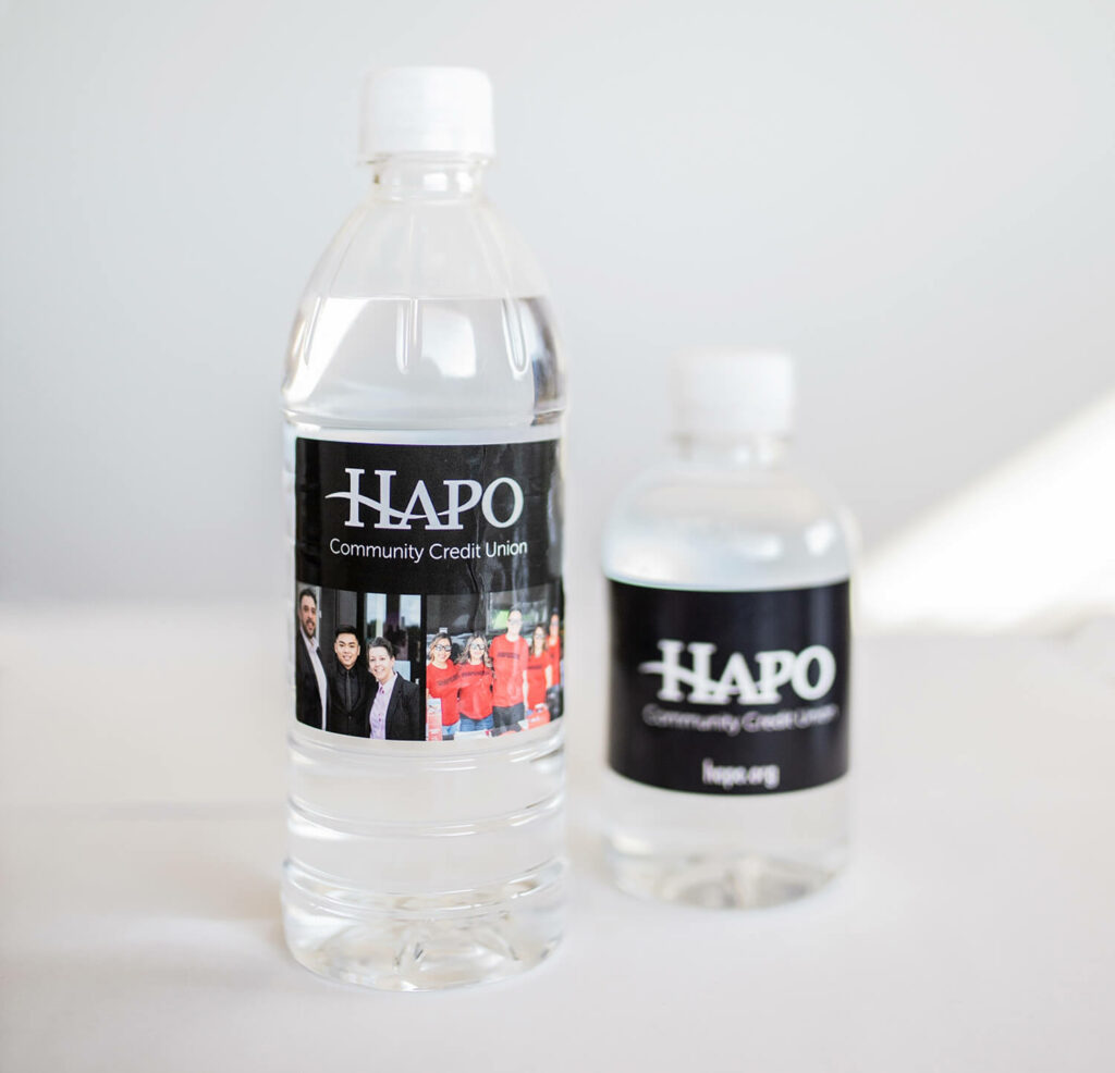 Two sizes of water bottles with custom labels for the same Credit Union, as an example