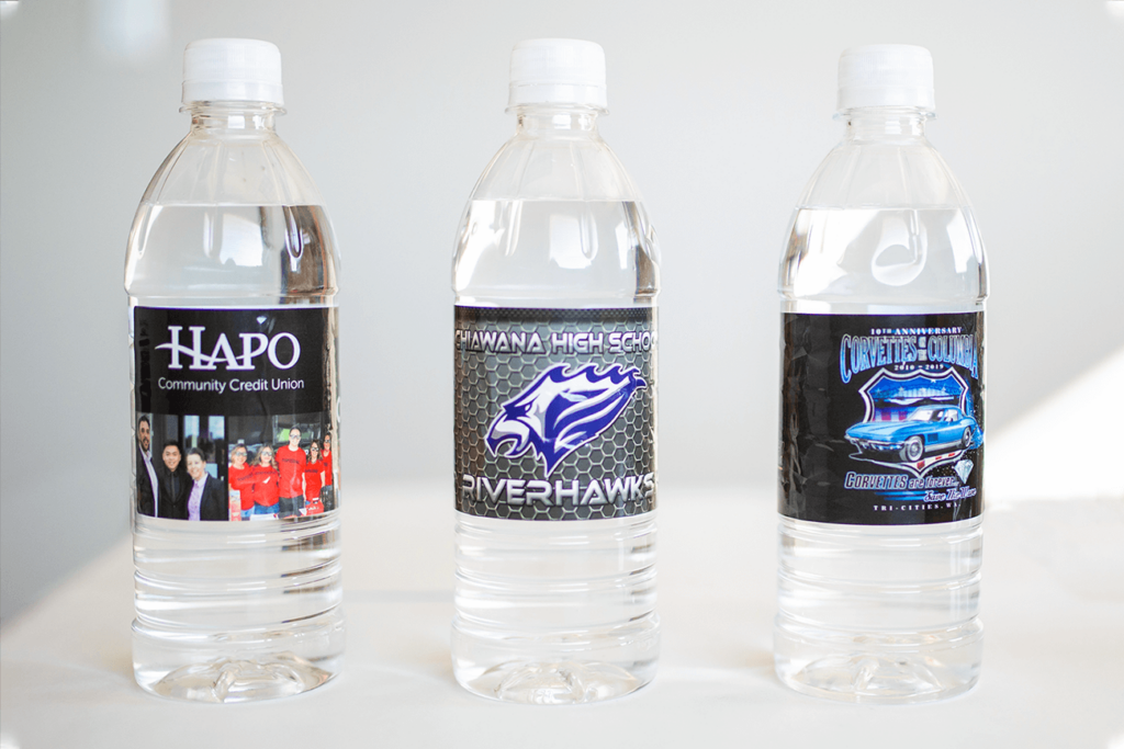 Three Water Bottles Showing Three Custom Labels sitting on white table