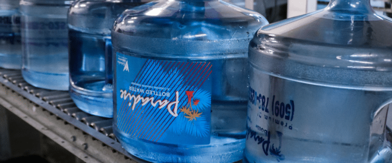 A row of 3-gallon water jugs.