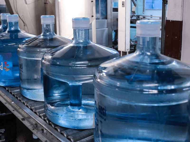 A row of 3-gallon water jugs