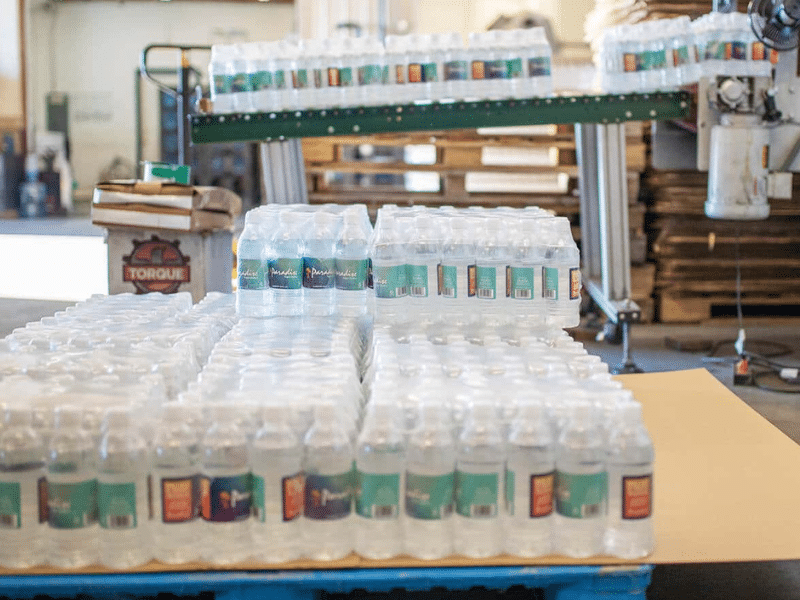 Cases of Paradise Bottled Water stacked on a pallet