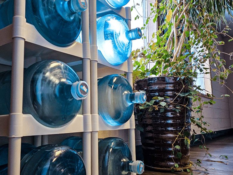 5-gallon water jugs stacked in a jug holder